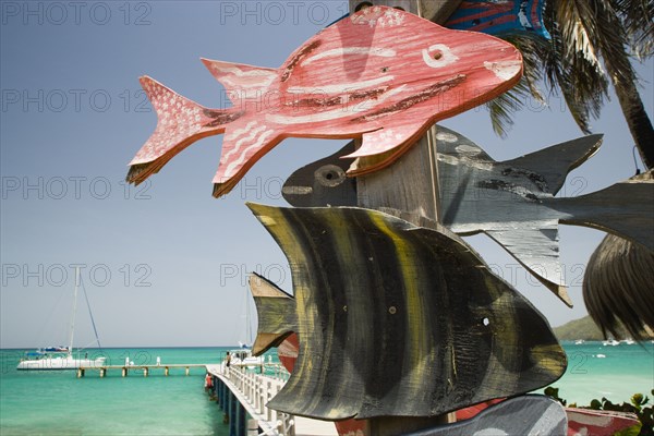 WEST INDIES, St Vincent & The Grenadines, Canouan, Signs on jetty in Charles Bay