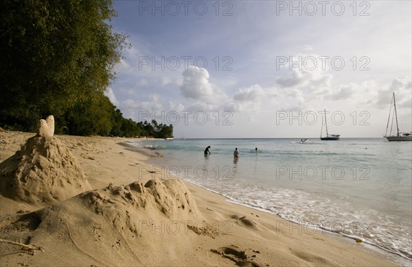 WEST INDIES, Barbados, St Peter, Gibbes Bay beach in the late afternoon with sandcastles at the waters edge