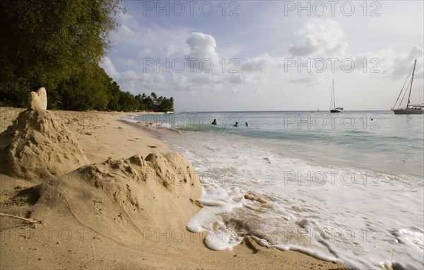 WEST INDIES, Barbados, St Peter, Gibbes Bay beach in the late afternoon with sandcastles at the waters edge