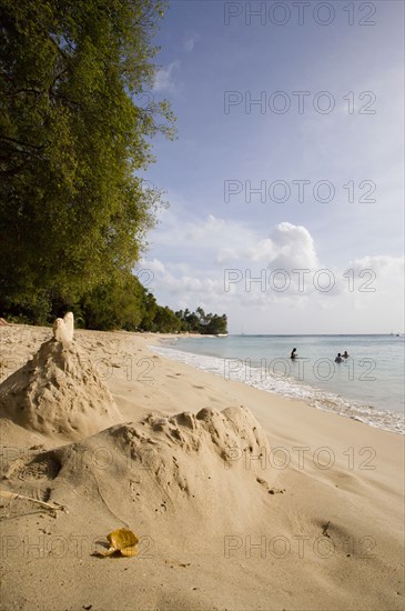 WEST INDIES, Barbados, St Peter, Gibbes Bay beach in the late afternoon with sandcastles at the waters edge