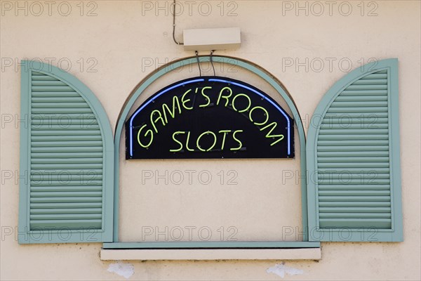 WEST INDIES, Barbados, St James, Gambling rooms neon sign in faked window promoting Slots in Holetown