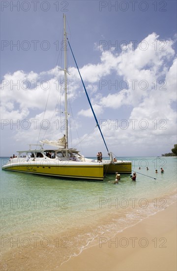 WEST INDIES, Barbados, St Peter, Catamaran with tourists moored on Gibbes Beach