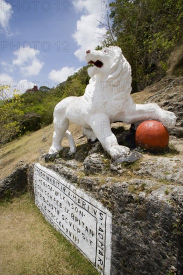 WEST INDIES, Barbados, St George, Imperial lion carved from coral rock by British soldiers serving at Gun Hill signal station with the station on the hill in the distance
