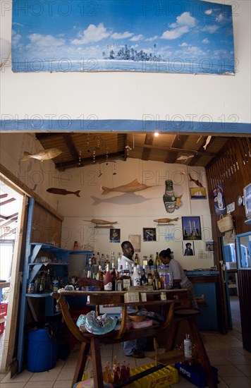 WEST INDIES, St Vincent & The Grenadines, Bequia, Bar and staff at beachside restaurant on Lower Bay