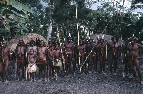 INDONESIA, Irian Jaya, Baliem Valley, Dani villagers preparing for a mock battle.