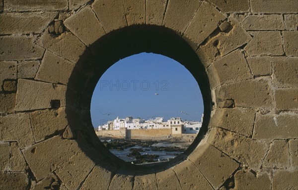 MOROCCO, Essaouira, Fortified coastal town framed in circular opening in wall.