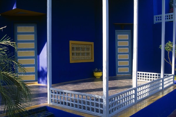 MOROCCO, Marrakesh, The Jardin Majorelle owned by Yves St Laurent.  Corner of balcony with walls painted vivid blue.