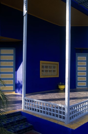 MOROCCO, Marrakesh, The Jardin Majorelle owned by Yves St Laurent.  Corner of balcony with walls painted vivid blue.