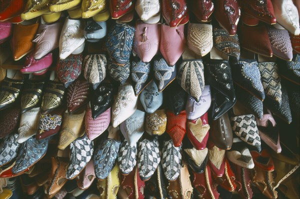 MOROCCO, Fes, Display of embroidered and decorated leather slippers or babouches.