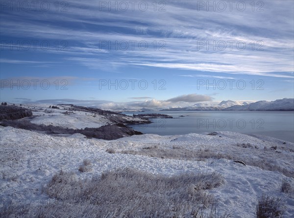 SCOTLAND, Highland, Isle of Skye, View north east along the Sound of Sleat from Ard Thurnish in heavy snow.
