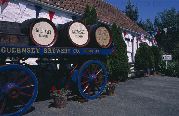 UNITED KINGDOM, Channel Islands, Guernsey, Forest Parish. German Occupation Museum. Brewery barrels on cart displayed outside main entrance.