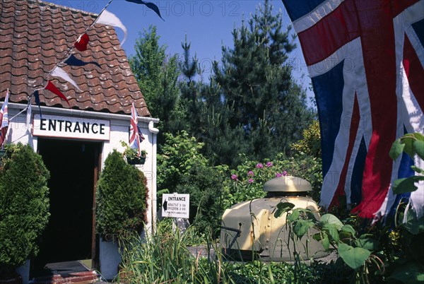 UNITED KINGDOM, Channel Islands, Guernsey, Forest Parish. German Occupation Museum. Main entrance with Union Jack flag flying in forground.