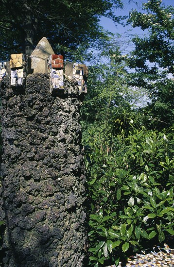 UNITED KINGDOM, Channel Islands, Guernsey, St Andrews. Les Vauxbelets. The Little Chapel. Detail of stone post with china and pottery pieces