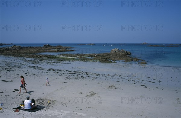 UNITED KINGDOM, Channel Islands, Guernsey, Castel. Cobo Bay. View across beach with families on the sand