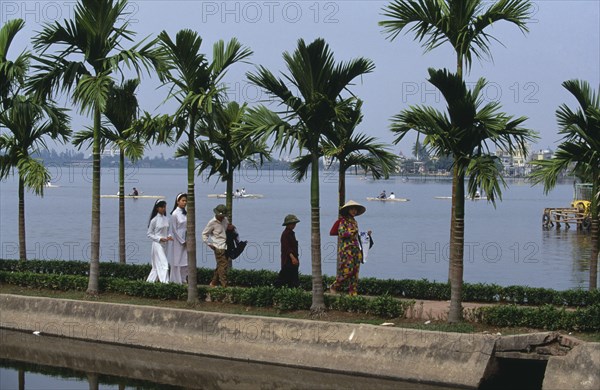 VIETNAM, North, Hanoi, People on the causeway to Tran Quoc Pagoda beside West Lake in popular recreational area north west of the city.