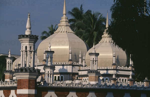 MALAYSIA, Kuala Lumpur, Masjid Jamek or Friday Mosque.  Exterior with domed roof and red and white striped minarets.