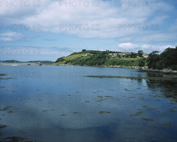 IRELAND, County Kerry, Ring of Kerry, Beara Peninsula. View over water towards boats and houses on a hill .