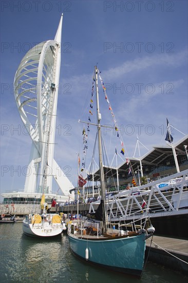 ENGLAND, Hampshire, Portsmouth, The Spinnaker Tower the tallest public viewing platforn in the UK at 170 metres on Gunwharf Quay with moorings in the foreground