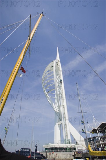 ENGLAND, Hampshire, Portsmouth, The Spinnaker Tower the tallest public viewing platforn in the UK at 170 metres on Gunwharf Quay with yachts mast in the foreground