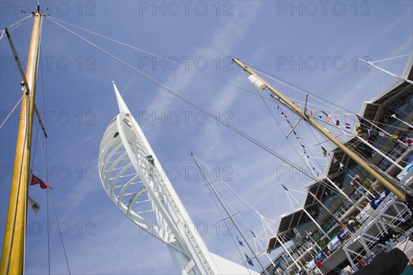 ENGLAND, Hampshire, Portsmouth, The Spinnaker Tower the tallest public viewing platforn in the UK at 170 metres on Gunwharf Quay with yachts mast in the foreground