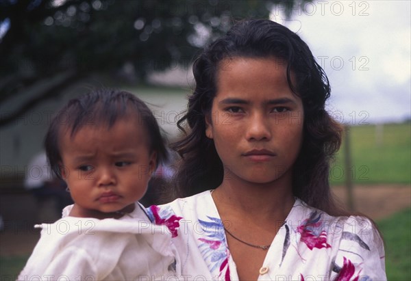 COLOMBIA, Casanare, A Llanera woman holding a child.