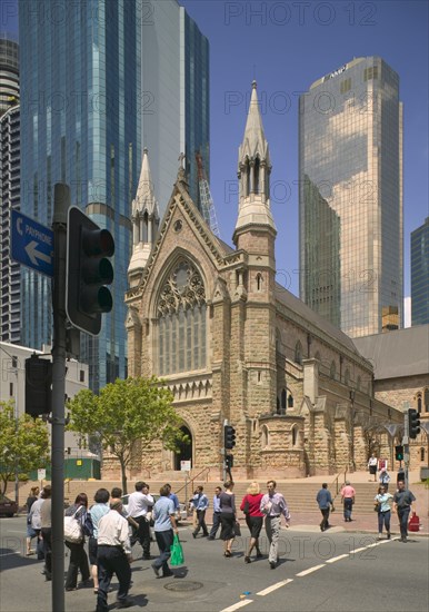 AUSTRALIA, Queensland, Brisbane, People crossing over a road in front of St Stephen's Cathedral.