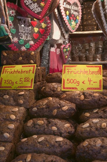GERMANY, Bavaria, Nuremberg, "Stall selling Fruchtebrot and Lebkuchen, traditional German festive food, in the Christmas Market in Hauptmarkt."