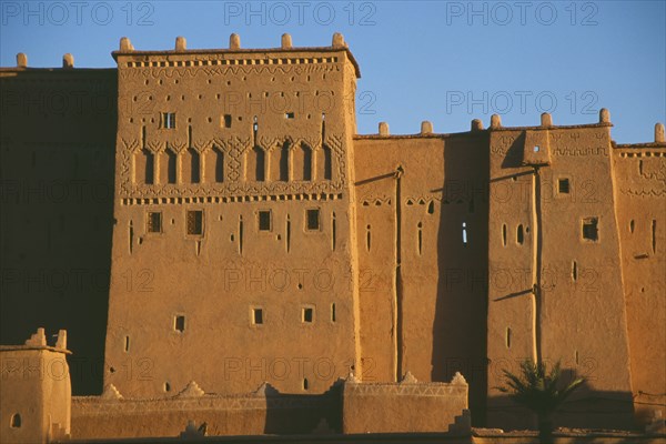 MOROCCO, Ouarzazate, Kasbah Taorirt .  Nineteenth century kasbah of the el-Glaoui dynasty.  Exterior walls partly in deep shadow.