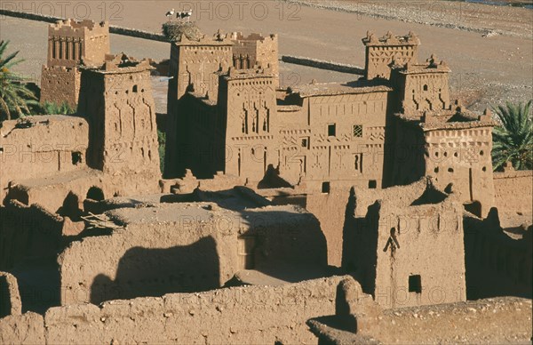 MOROCCO, Ait Benhaddou, Elevated view over kasbah used in films including Lawrence of Arabia and Jesus of Nazareth with storks nesting on fortified tower.