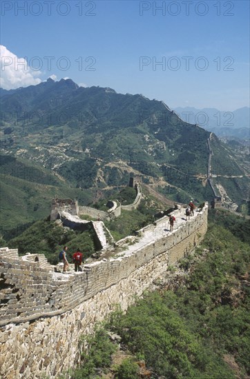 CHINA, Hebei, Simatai, "View of the Great Wall winding through the mountains into the distance. People walking on the wall, rebuilt 1567 to 70"