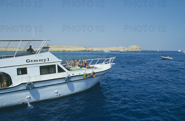 EGYPT, Red Sea Coast, Ras Mohammed, Divers prepare to dive off boat.