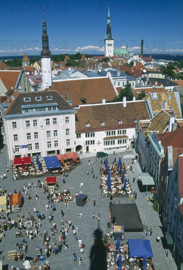 ESTONIA, Tallinn, View over busy Town Hall Square towards spires of St Olaf’s Church of the Holy Ghost.