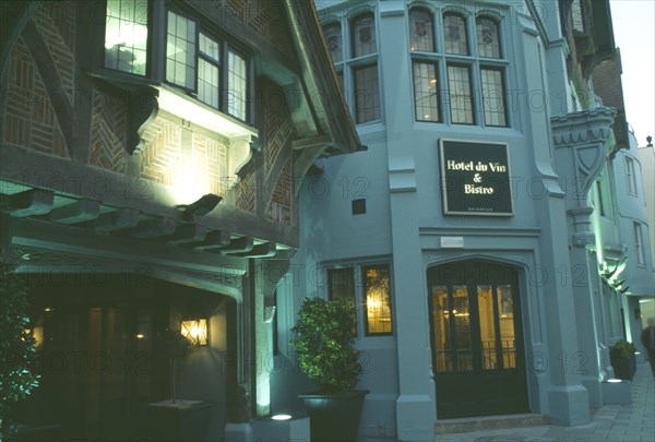 ENGLAND, East Sussex, Brighton, Hotel Du Vin frontage lit up in evening light.