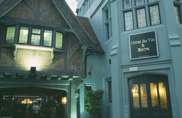 ENGLAND, East Sussex, Brighton, Hotel Du Vin frontage lit up in evening light.