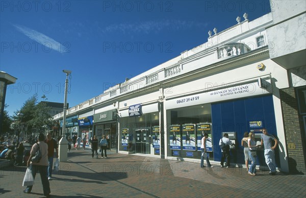 ENGLAND, East Sussex, Eastbourne, Busy pedestrian shopping area with people using cash machines.