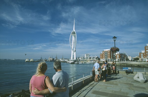 ENGLAND, Hampshire, Portsmouth, Spice Island. A couple arm in arm looking towards the Spinnaker Tower.