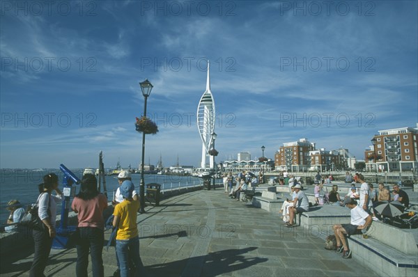 ENGLAND, Hampshire, Portsmouth, Spice Island. Groups of people looking towards the Spinnaker Tower.