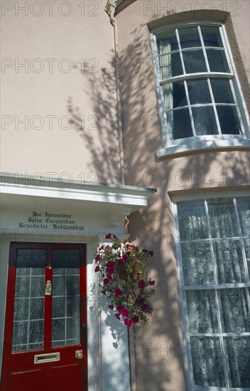 ENGLAND, Hampshire, Portsmouth, Old Portsmouth. Pink Town house with Latin Script written above red door.