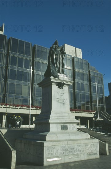 ENGLAND, Hampshire, Portsmouth, Guildhall Square. Statue of Queen Victoria with Council offices behind.