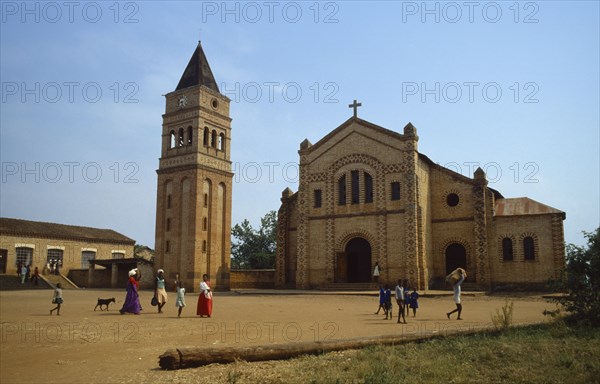 RWANDA, Religion, Missionary church and school with women and children walking across courtyard in foreground.