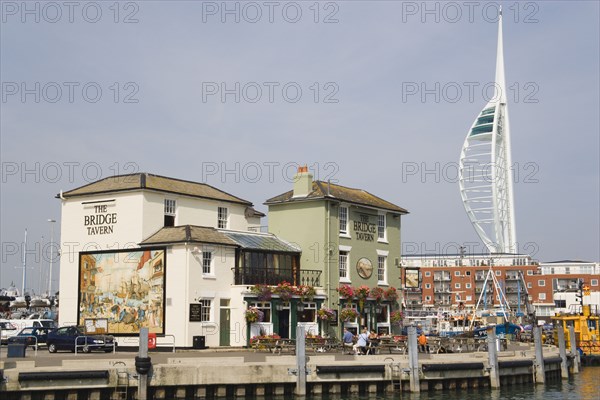 ENGLAND, Hampshire, Portsmouth, The Camber in Old Portsmouth showing the Spinnaker Tower behind the Bridge Tavern with its mural of Thomas Rowlansons cartoon titled Portsmouth Point.