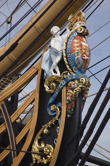 ENGLAND, Hampshire, Portsmouth, The bow of HMS Victory in the Historic Dockyard showing the bow figurehead with Royal crest.