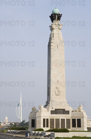 ENGLAND, Hampshire, Portsmouth, World War One Naval Memorial obelisk on Southsea seafront designed by Sir Robert Lorimer with sculpture by Henry Poole with the Spinnaker Tower and the Anglican Cathedral Of St Thomas beyond.