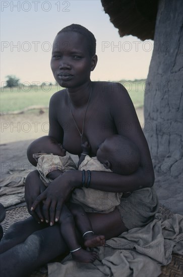 SUDAN, Children, Twins, Dinka mother breastfeeding twin babies.