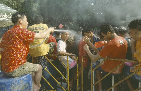 THAILAND, Bangkok, "Crowd having a water fight,  celebrating the Songkhran Festival. Thai New Year, 15 April."