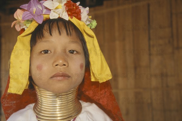 THAILAND, Chiang Rai, "Portrait of young Paduang girl, long neck, metal rings."