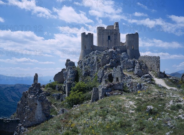 ITALY, Abruzzo, Castel del Monte, "The ruins of Castel Roche, on side of mountain"