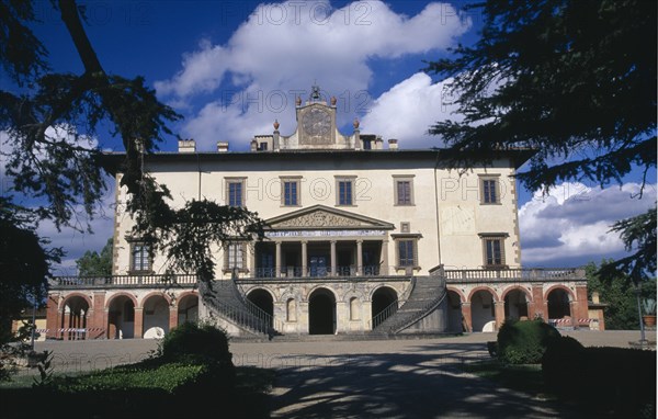 ITALY, Tuscany, Near Florence, Villa Medici Poggio a Caiano.  Country villa near Florence built by Lorenzo the Magnificent.  Exterior facade framed by trees.