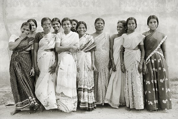 INDIA, Tamil Nadu, Vellamadam, Female workers at St. Joseph's Orphanage smile and laugh for the camera.