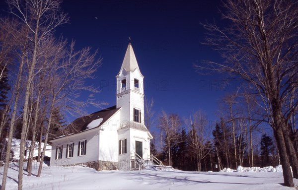 USA, New Hampshire, Jefferson, "Saint Johns United Methodist Church, small white building with spire and steps leading to entrance, surrounded by snow with some on roof."